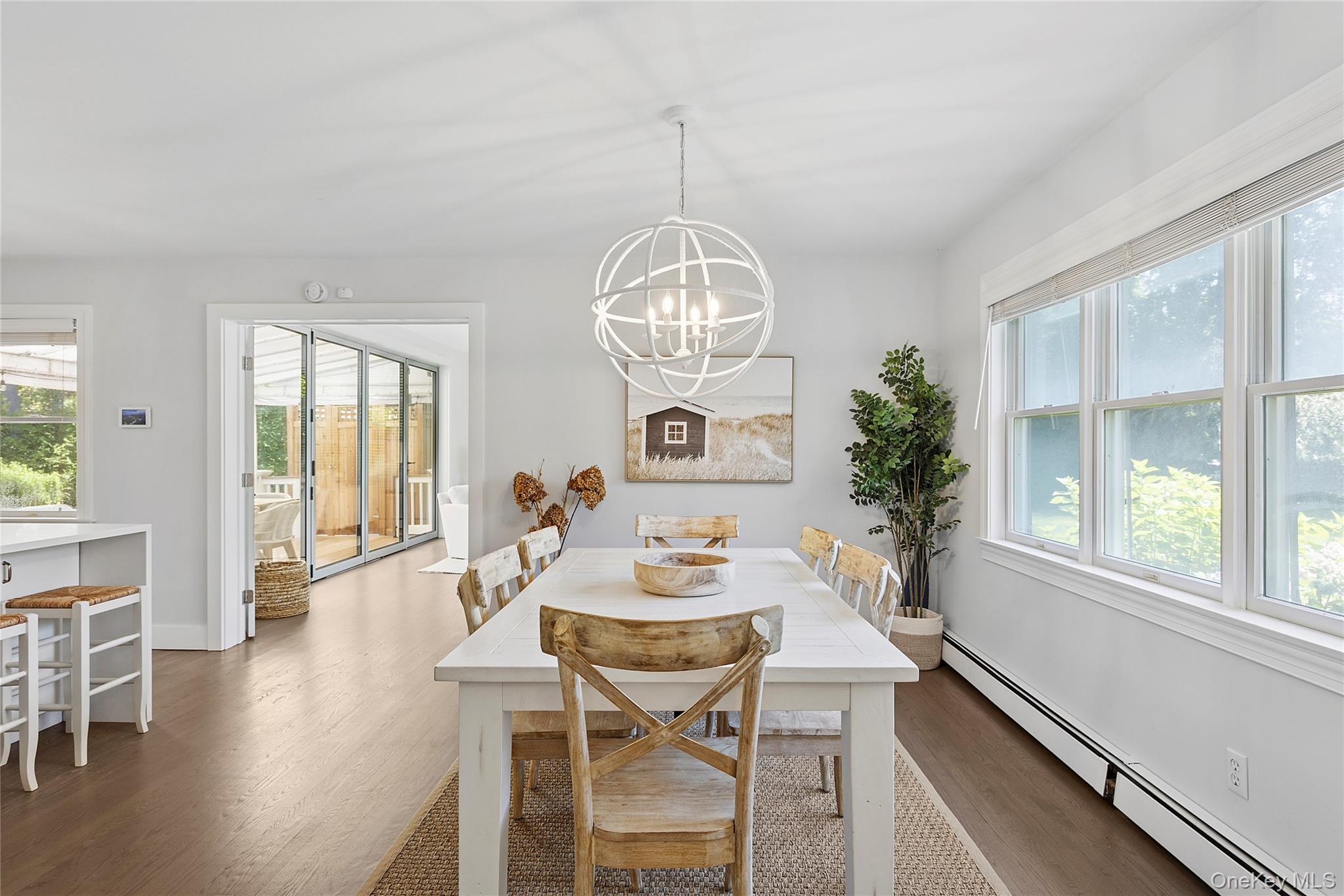 31 Highland Road Southampton, NY 11968 - Photo 5 of 19 Dining space featuring a baseboard heating unit, plenty of natural light, and dark wood-style floors
