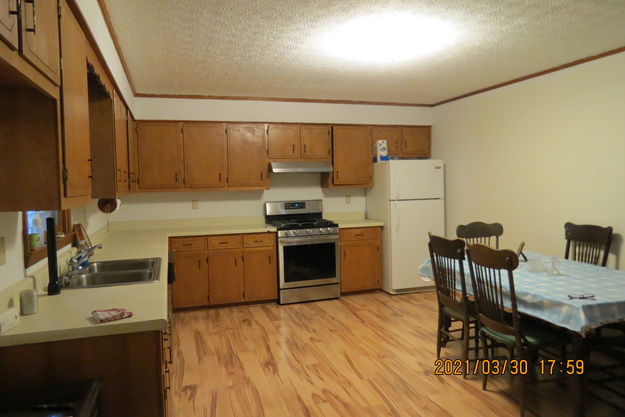876 Denmark Road Erin, TN 37061 - Photo 18 of 45 a kitchen with granite countertop a stove and a refrigerator