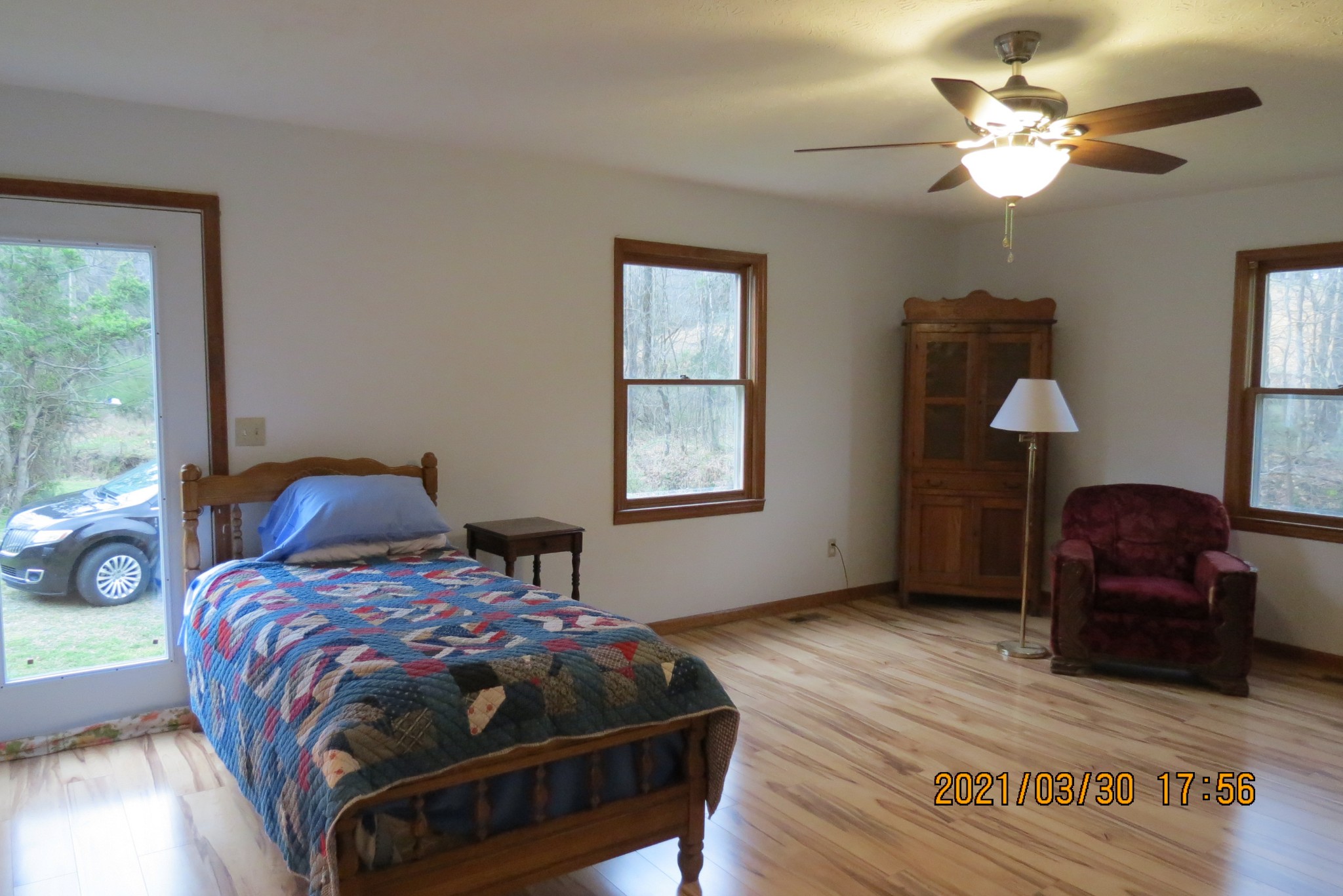 876 Denmark Road Erin, TN 37061 - Photo 20 of 45 a bedroom with a bed and a chandelier