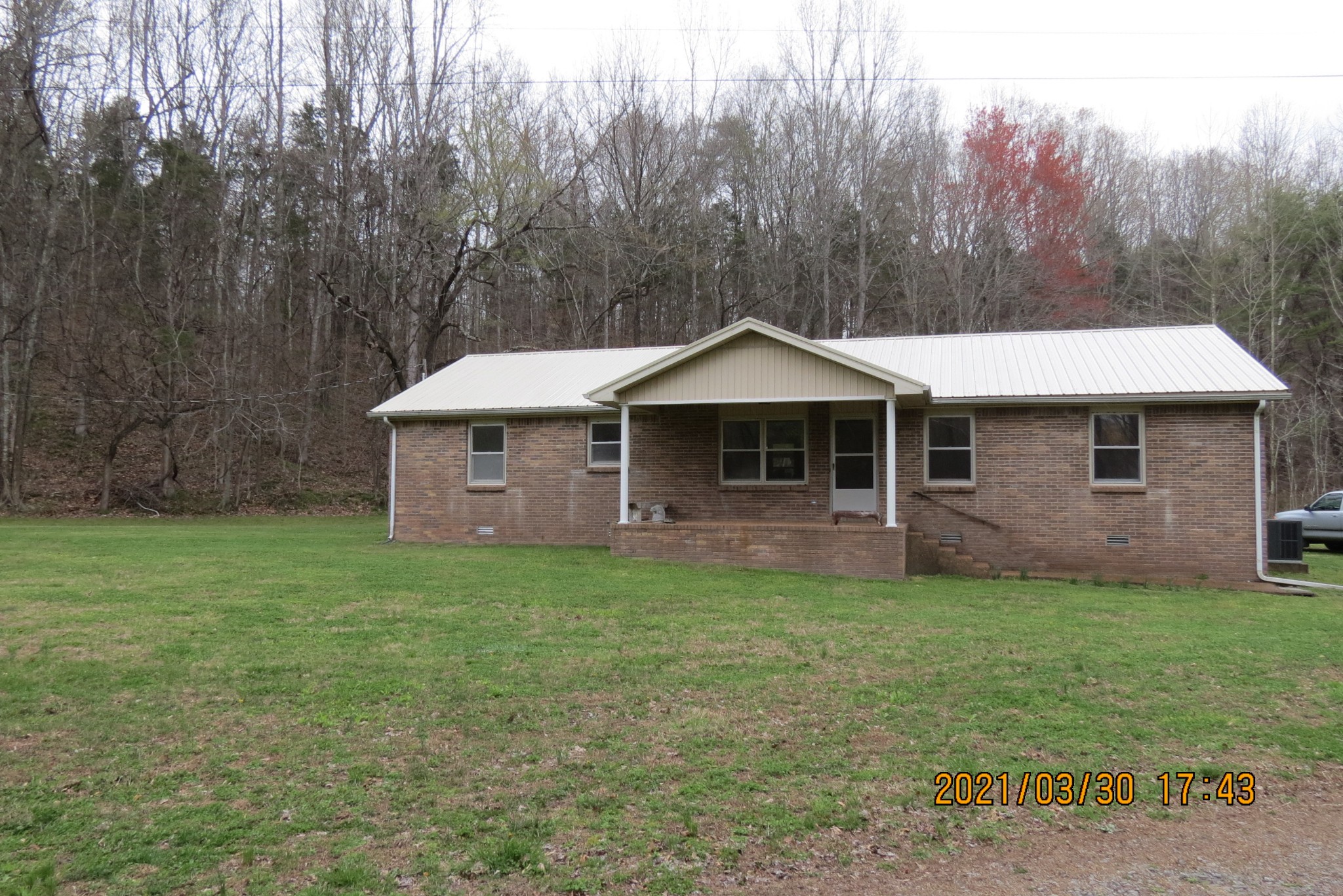 876 Denmark Road Erin, TN 37061 - Photo 21 of 45 a front view of a house with a garden