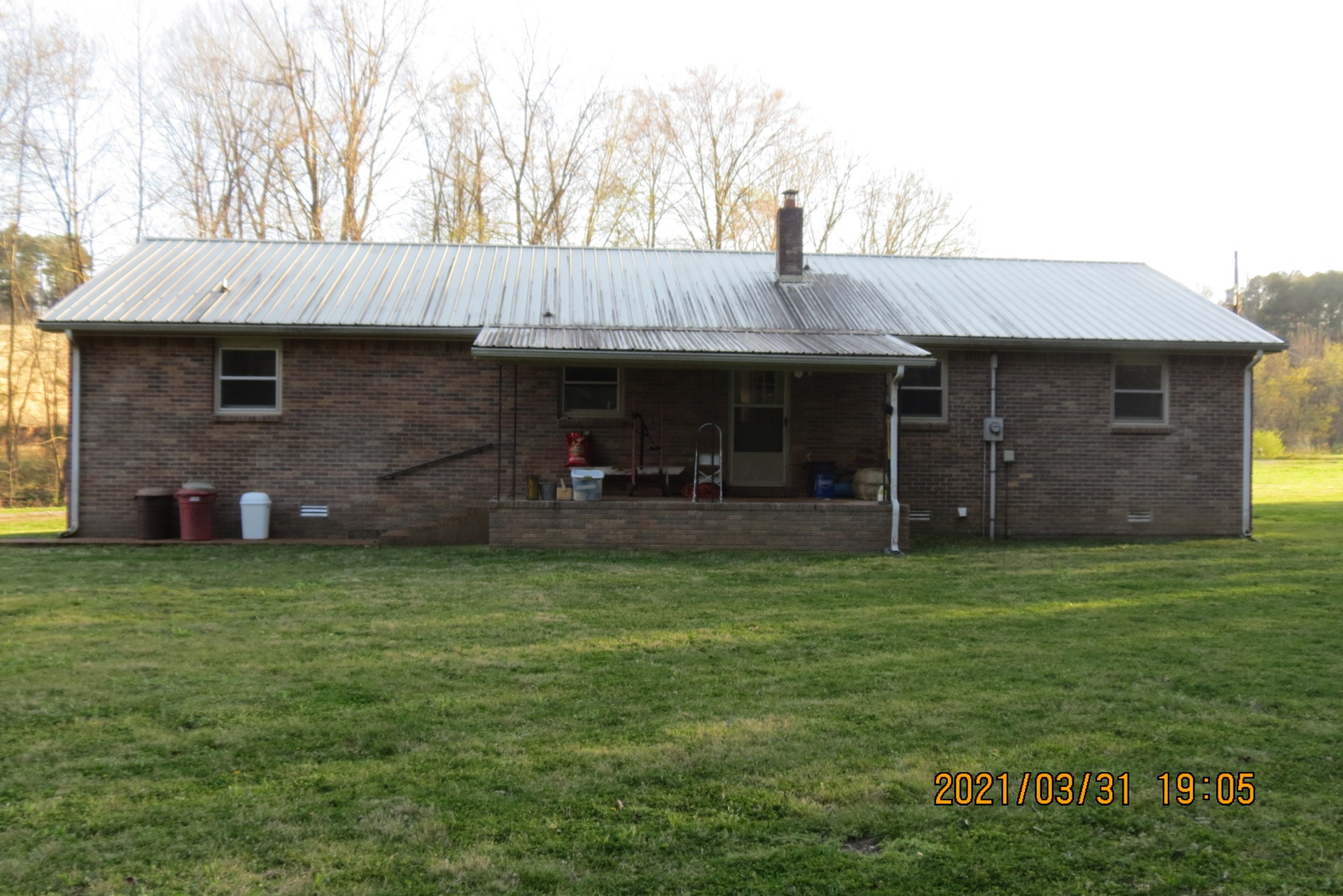 876 Denmark Road Erin, TN 37061 - Photo 23 of 45 a backyard of a house with table and chairs