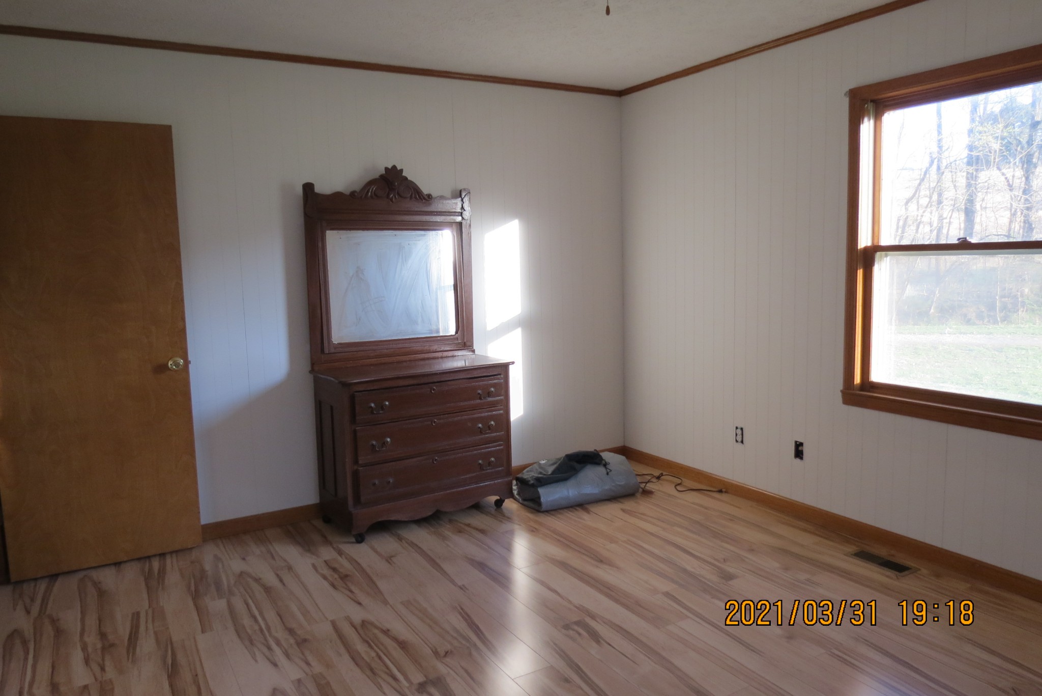 876 Denmark Road Erin, TN 37061 - Photo 27 of 45 a view of an empty room with wooden floor and a window
