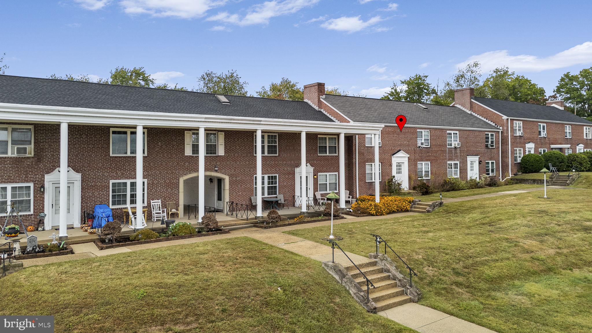 200 Maplewood Drive, Unit D8 Pottstown, PA 19464 - Photo 2 of 12 front view of a house with a swimming pool