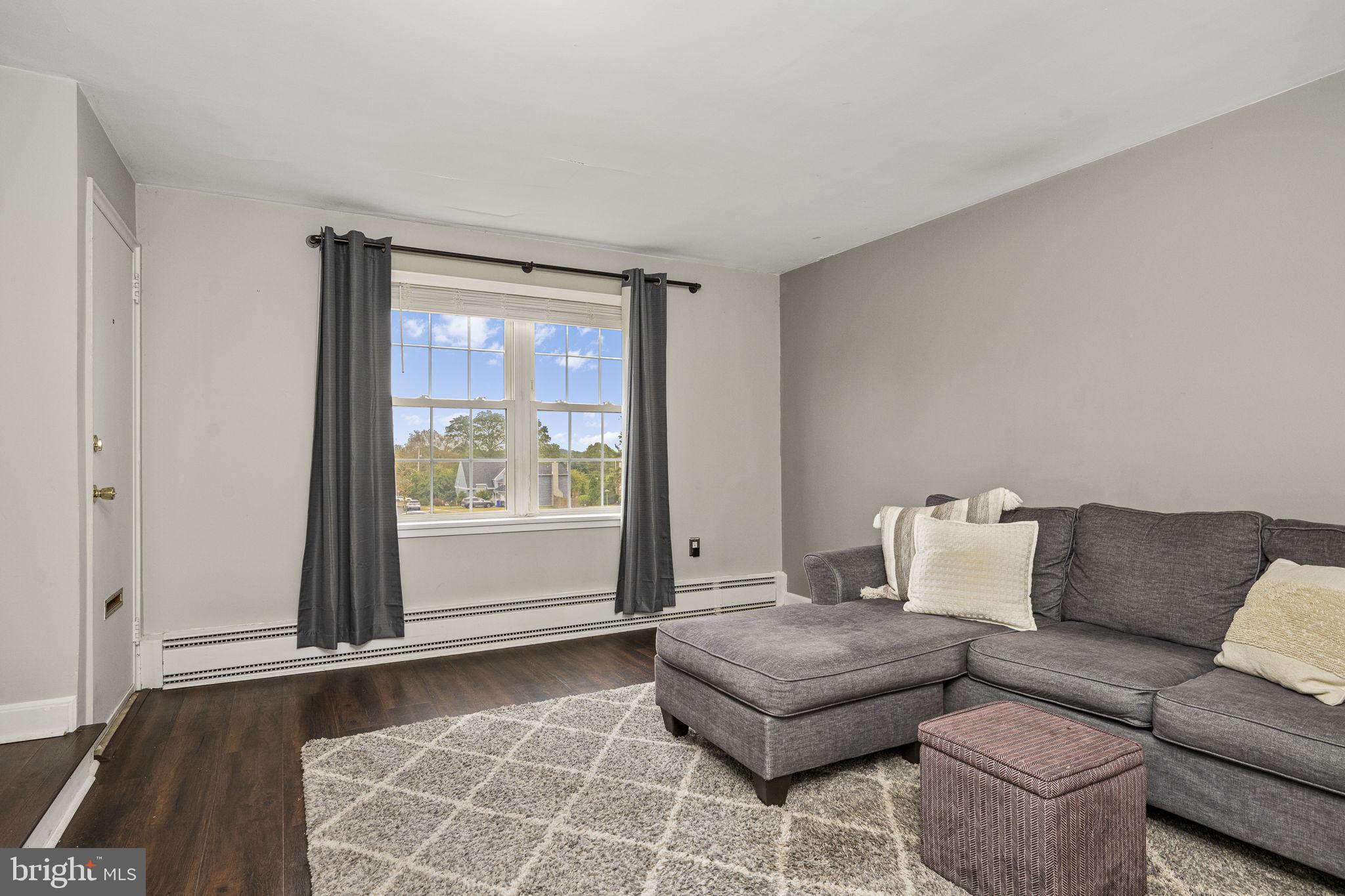 200 Maplewood Drive, Unit D8 Pottstown, PA 19464 - Photo 3 of 12 a living room with furniture and a window