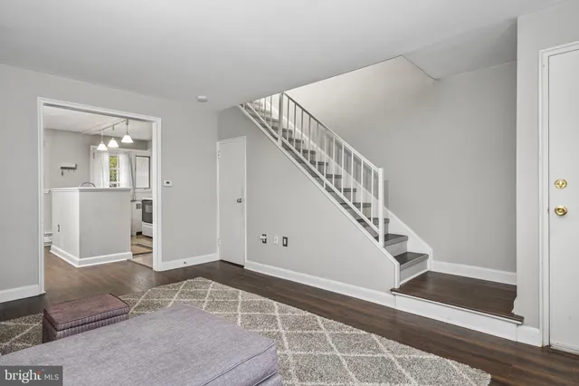a view of entryway and hall with wooden floor