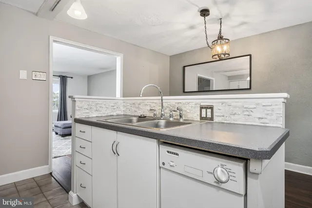 a bathroom with a granite countertop sink a large mirror and vanity