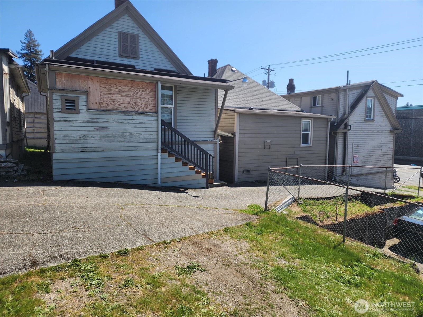 1637 Center Street Tacoma, WA 98409 - Photo 8 of 10 a house that has a small yard and a large window