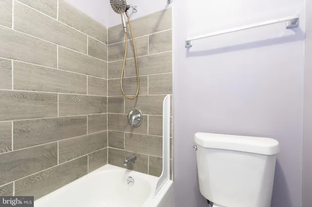 a bathroom with a shower a toilet and a sink