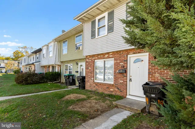 a front view of a house with a yard and porch