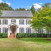 a front view of a house with a garden and yard