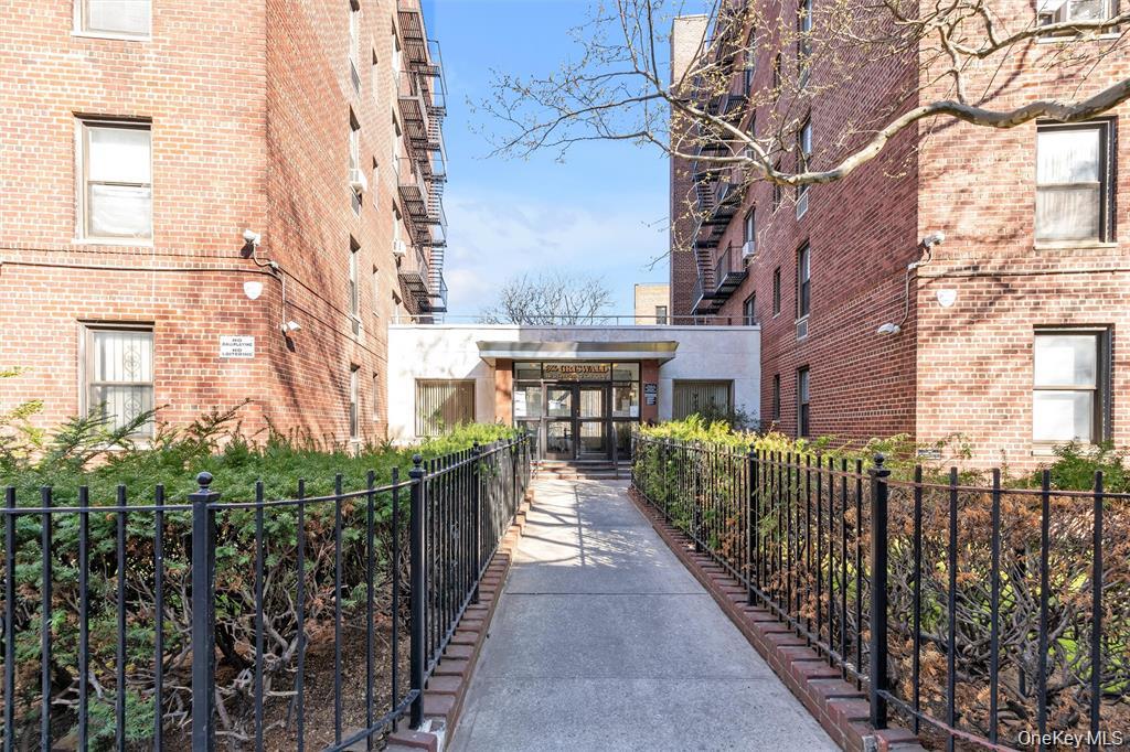 141-05 Pershing Crescent, Unit 207 Queens, NY 11435 - Photo 3 of 13 a view of a brick house with wooden fence