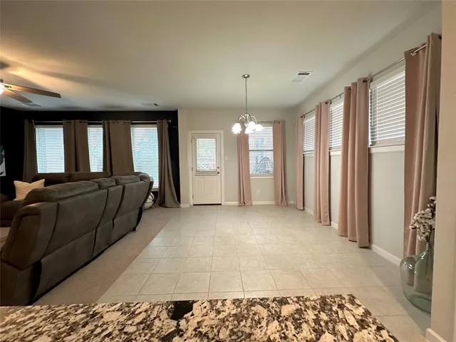 a living room with a couch and a chandelier