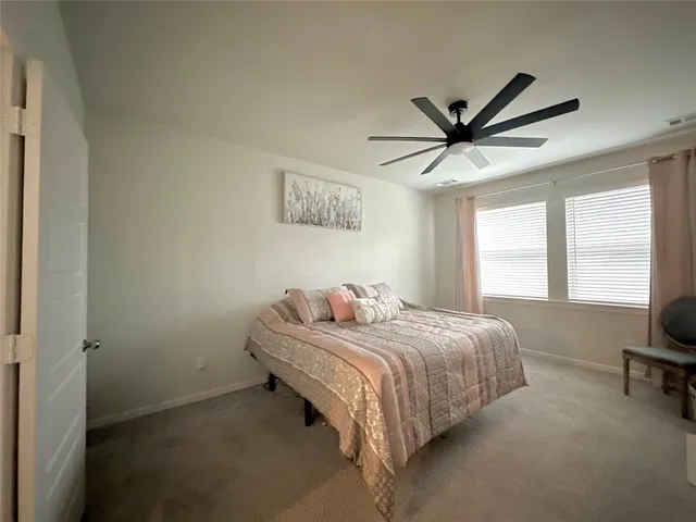 a bedroom with a bed and a large window