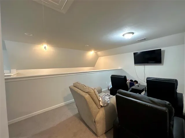 a media room with lots of chairs and a projector screen