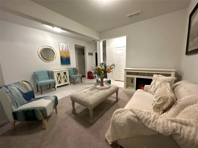 a living room with furniture and a fireplace