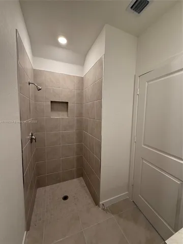 a bathroom with a shower and toilet