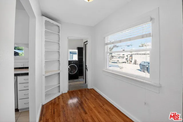 a view of hallway with wooden floor and stairs