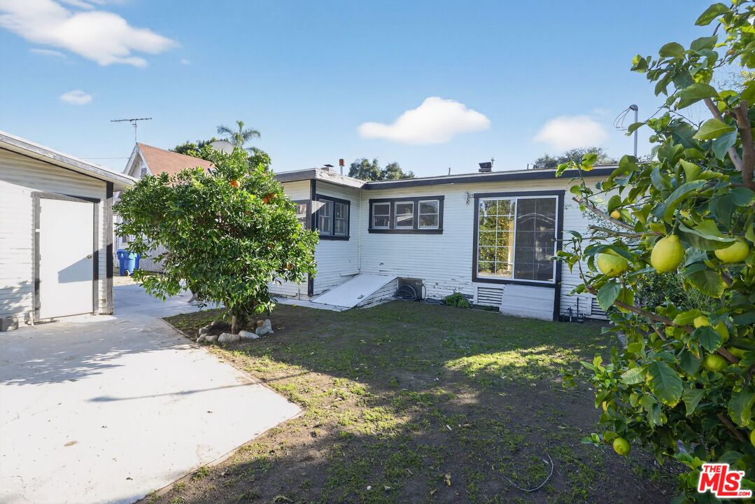 11029 Sarah Street Los Angeles, CA 91602 - Photo 27 of 27 a front view of a house with a yard and potted plants