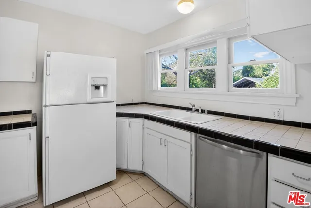 a kitchen with a refrigerator and a sink