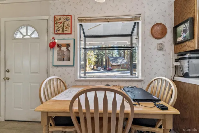 a view of a dining area with furniture and wooden floor