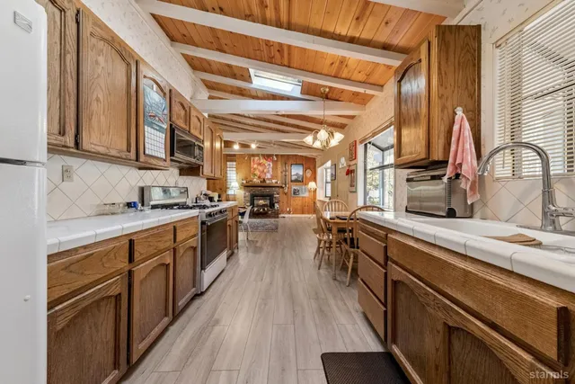 a kitchen with stainless steel appliances a sink and cabinets