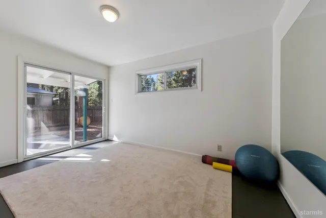 a view of a workspace with furniture and window