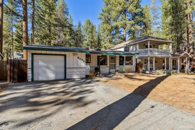 a front view of a house with garden and patio