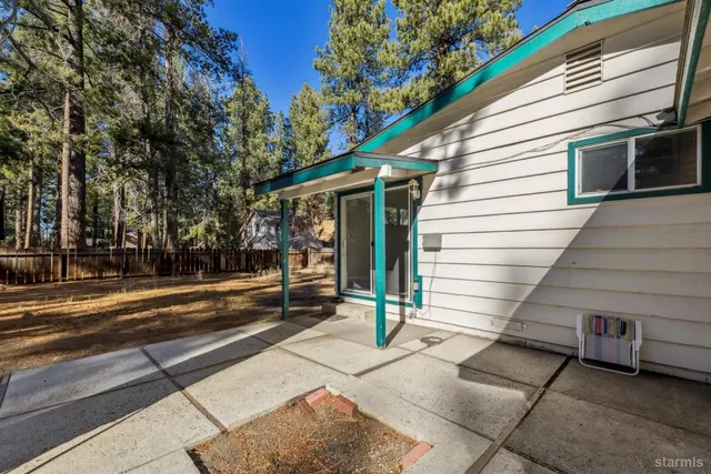 a view of a two chairs in the back yard