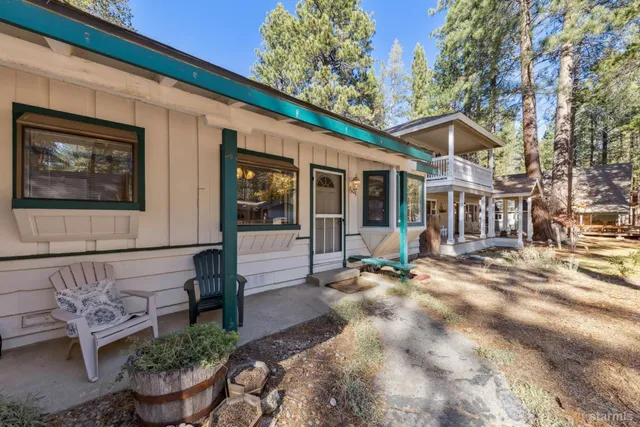 a view of a house with backyard sitting area and garden