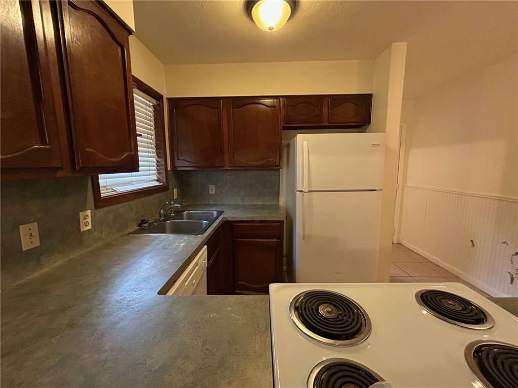 1913 Pine Tree Drive, Unit B Bryan, TX 77802 - Photo 5 of 13 a kitchen with a refrigerator and a stove top oven