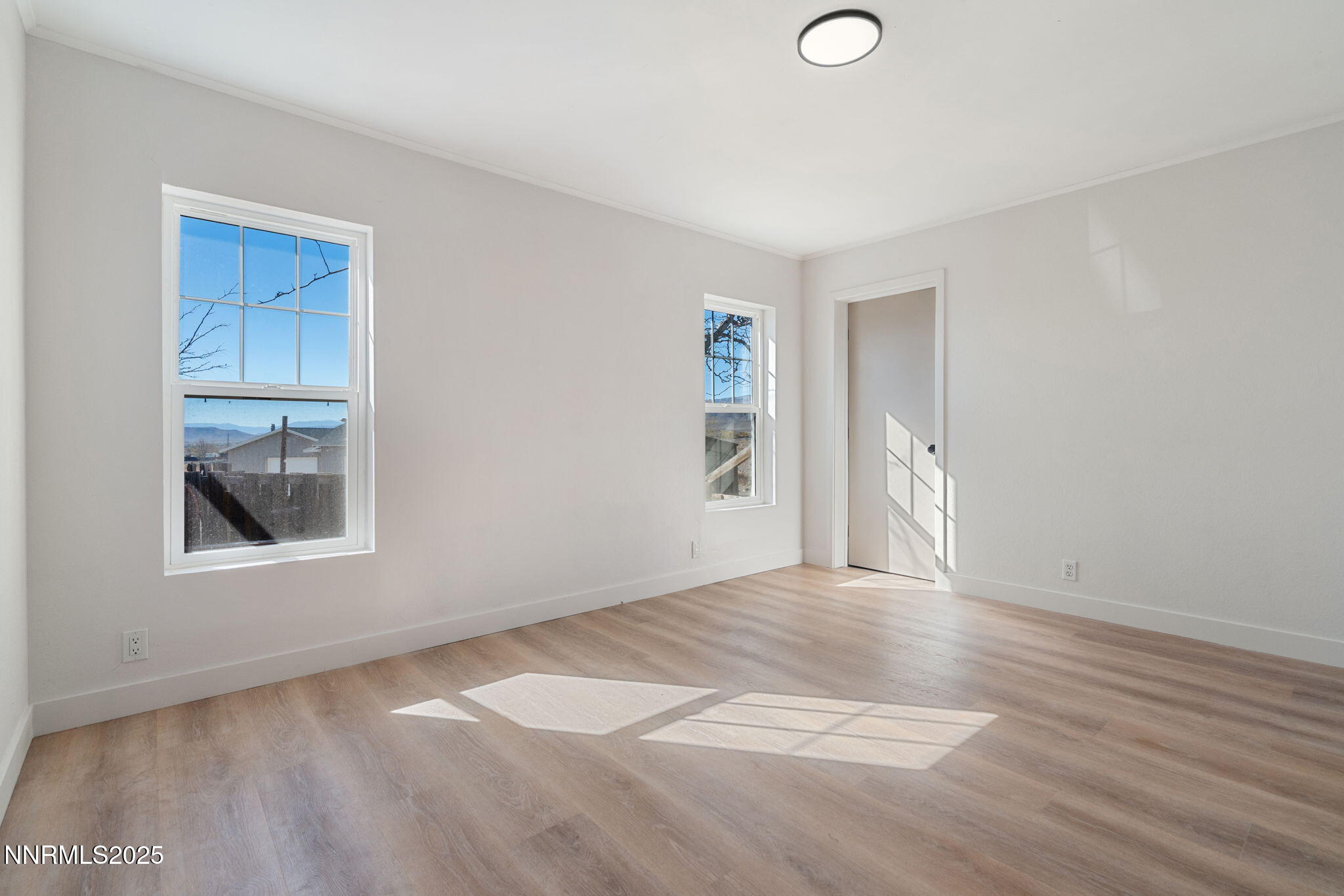 4925 Cheyenne Trail Silver Springs, NV 89429 - Photo 13 of 35 a view of empty room with wooden floor and fan