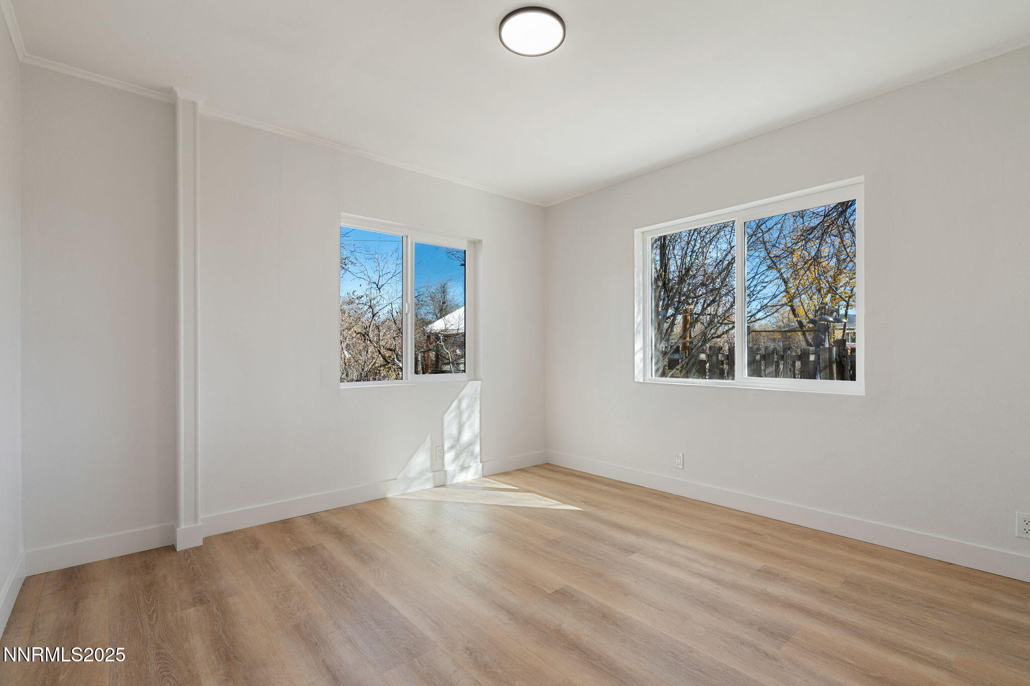 4925 Cheyenne Trail Silver Springs, NV 89429 - Photo 15 of 35 an empty room with wooden floor and windows