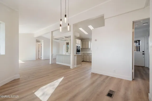a kitchen with white cabinets stainless steel appliances and sink