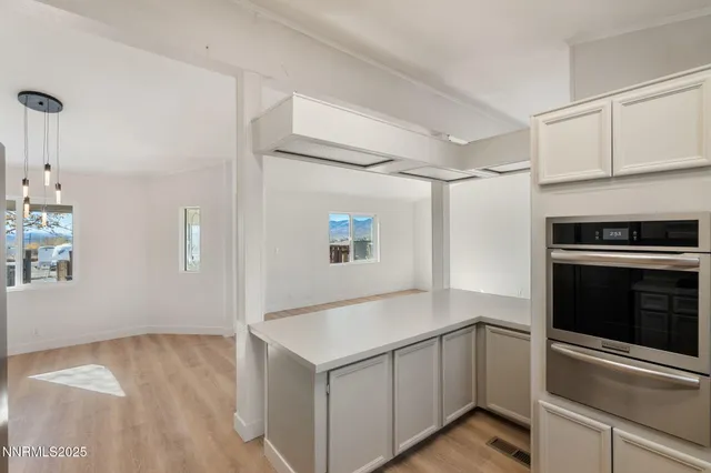 a kitchen with white cabinets and white appliances