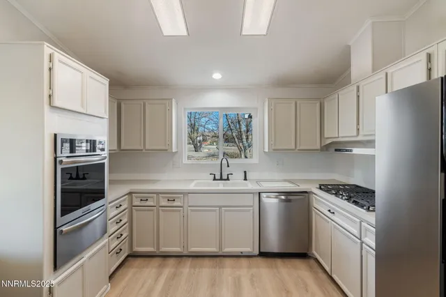 a kitchen with stainless steel appliances a stove a refrigerator and cabinets