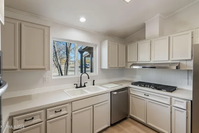 an empty room with wooden floor chandelier and windows