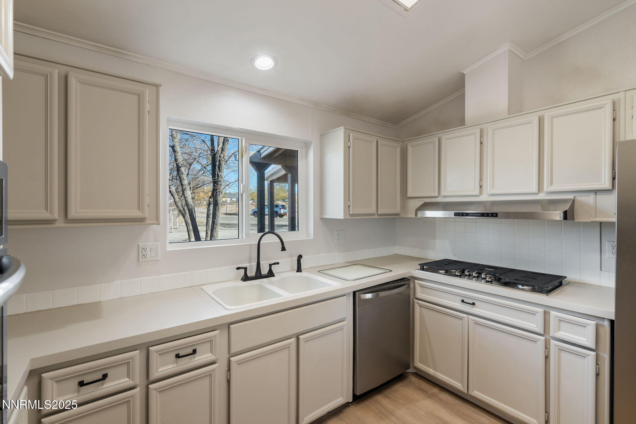 4925 Cheyenne Trail Silver Springs, NV 89429 - Photo 5 of 35 a kitchen with white cabinets and white appliances