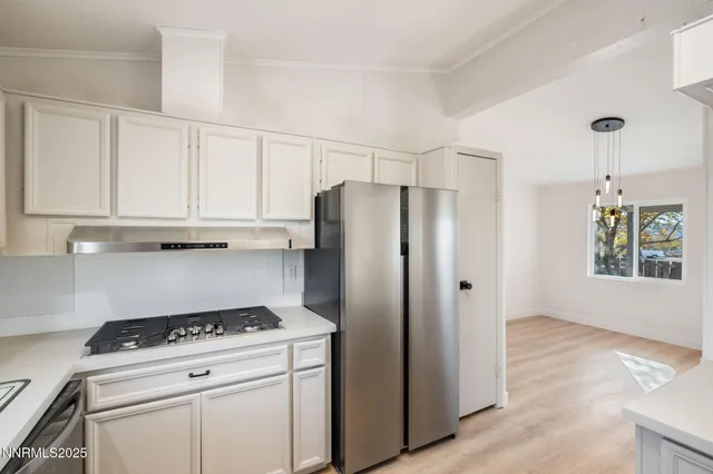 an empty room with wooden floor and a window