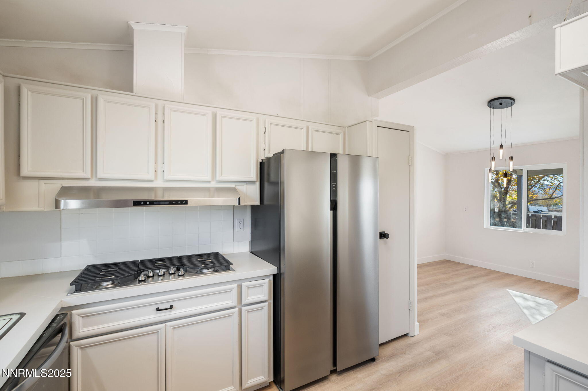 4925 Cheyenne Trail Silver Springs, NV 89429 - Photo 6 of 35 a kitchen with stainless steel appliances a stove a refrigerator and cabinets