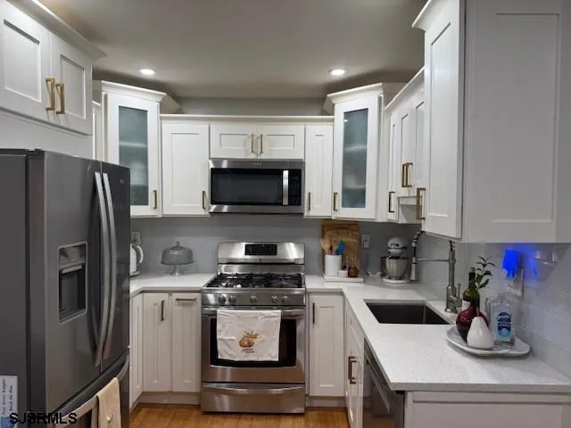 a kitchen with a refrigerator stove and microwave