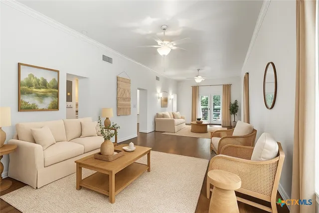a living room with furniture a large window and a chandelier