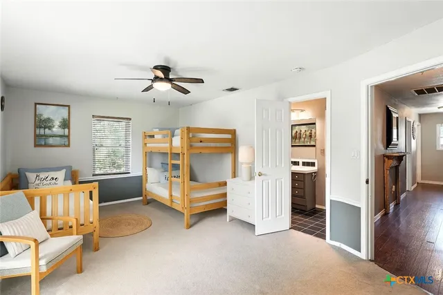 a bedroom with furniture and a ceiling fan