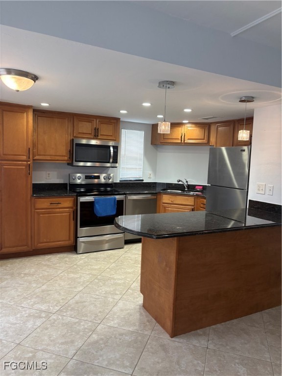 5031 Southwest 16th Place, Unit 101 Cape Coral, FL 33914 - Photo 1 of 10 a kitchen with stainless steel appliances granite countertop a sink a stove and a microwave