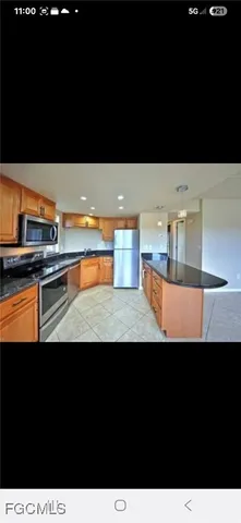 a view of kitchen island with stainless steel appliances