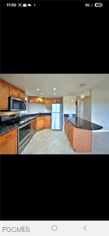 5031 Southwest 16th Place, Unit 101 Cape Coral, FL 33914 - Photo 5 of 10 a view of kitchen island with stainless steel appliances