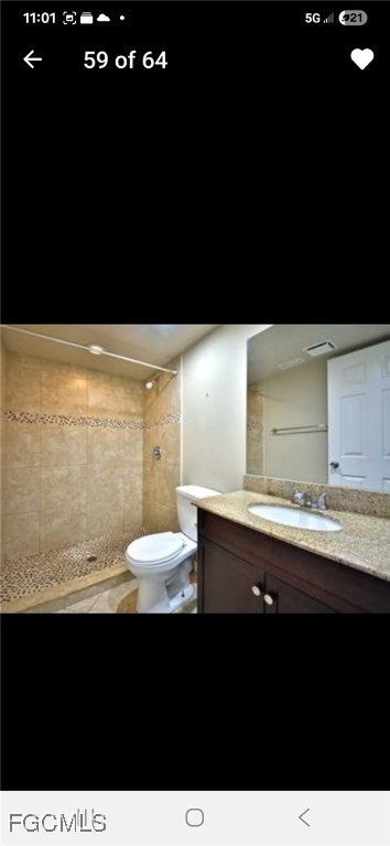 5031 Southwest 16th Place, Unit 101 Cape Coral, FL 33914 - Photo 6 of 10 a bathroom with a sink a toilet and a vanity