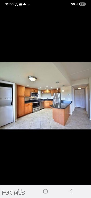 5031 Southwest 16th Place, Unit 101 Cape Coral, FL 33914 - Photo 7 of 10 a view of a living room with kitchen countertops and a potted plant