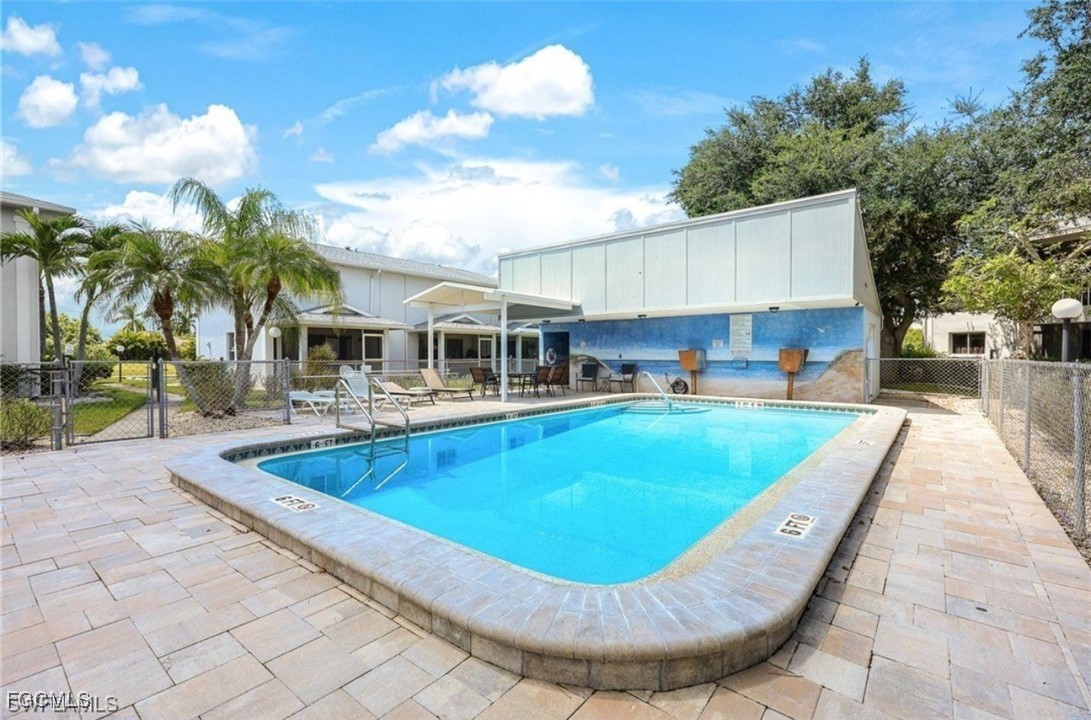 5031 Southwest 16th Place, Unit 101 Cape Coral, FL 33914 - Photo 9 of 10 a view of a swimming pool with a patio