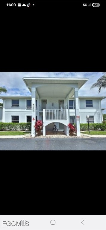 5031 Southwest 16th Place, Unit 101 Cape Coral, FL 33914 - Photo 10 of 10 a living room with furniture and a flat screen tv
