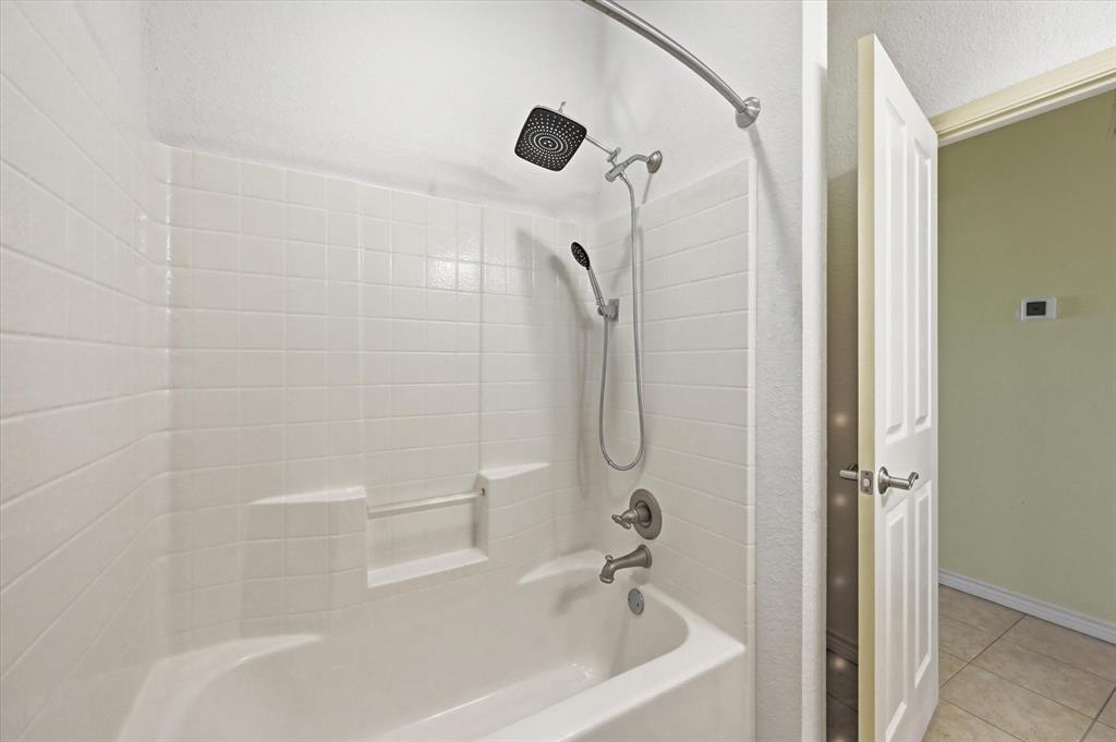 1616 Nash-Howard Road Waxahachie, TX 75165 - Photo 28 of 36 a bathroom with a shower and a bathtub